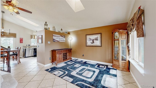 10517 Clermont Way, Thornton, CO 80233 - living area featuring a skylight, vaulted ceiling, light tile patterned floors, and ceiling fan