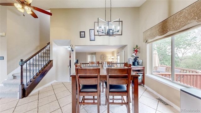 10517 Clermont Way, Thornton, CO 80233 - dining room with a towering ceiling, light tile patterned floors, a ceiling fan, stairs, and a chandelier