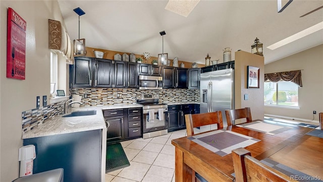 10517 Clermont Way, Thornton, CO 80233 - kitchen featuring stainless steel appliances, vaulted ceiling, backsplash, pendant lighting, and light tile patterned floors