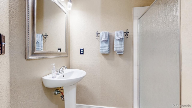 10517 Clermont Way, Thornton, CO 80233 - bathroom with an enclosed shower and a textured wall