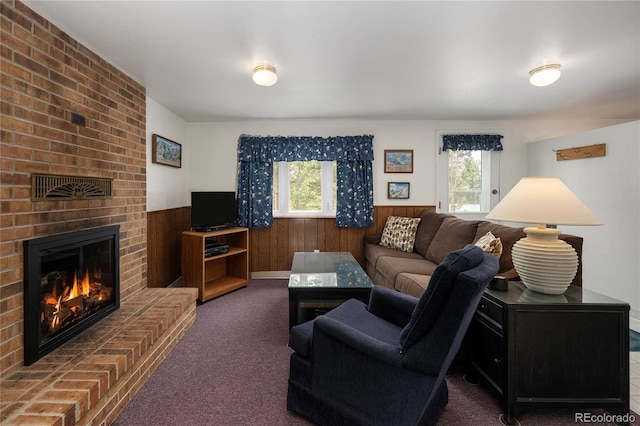 182 Colorado Dr, Tabernash, CO 80446 - carpeted living area featuring wainscoting, wood walls, and a fireplace