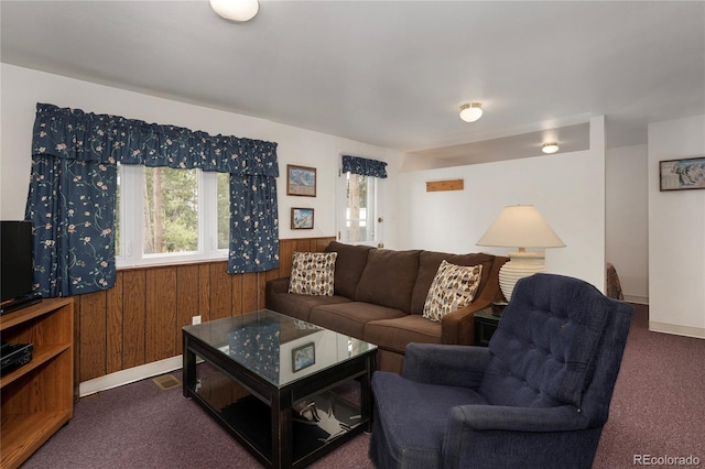 182 Colorado Dr, Tabernash, CO 80446 - living room with dark colored carpet, healthy amount of natural light, wood walls, a wainscoted wall, and baseboards