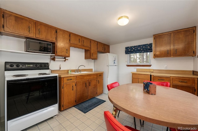 182 Colorado Dr, Tabernash, CO 80446 - kitchen featuring electric range, freestanding refrigerator, black microwave, a sink, and light countertops