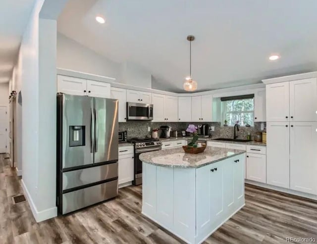 kitchen featuring a sink, white cabinets, tasteful backsplash, and stainless steel appliances