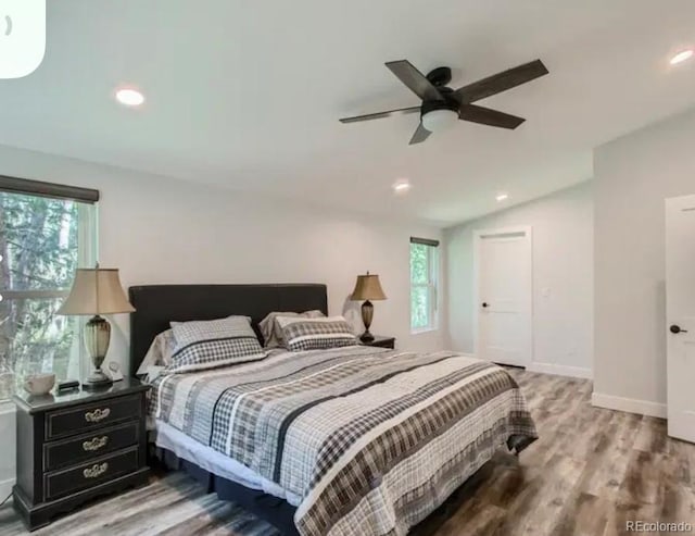 bedroom featuring recessed lighting, light wood-style floors, baseboards, ceiling fan, and vaulted ceiling