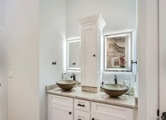 full bath with double vanity and a sink