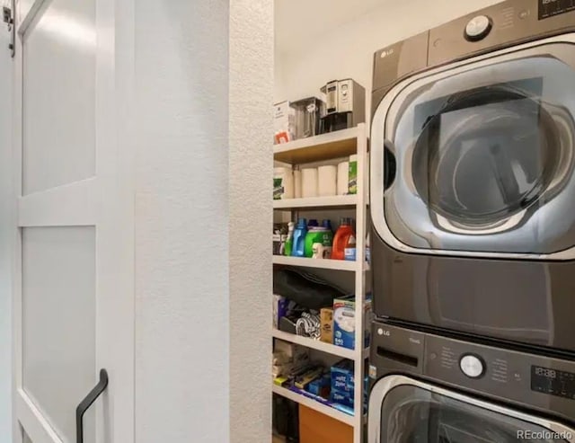 clothes washing area featuring laundry area and stacked washer and clothes dryer