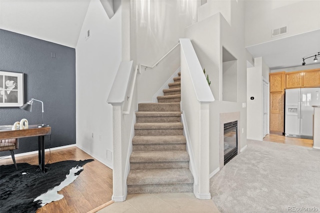 stairs featuring lofted ceiling and hardwood / wood-style flooring