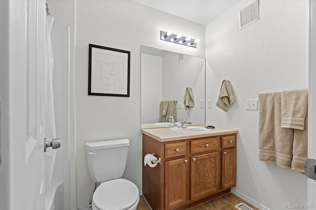 bathroom featuring vanity, tile patterned floors, toilet, and curtained shower