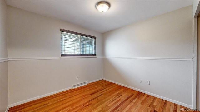 unfurnished room with hardwood / wood-style floors