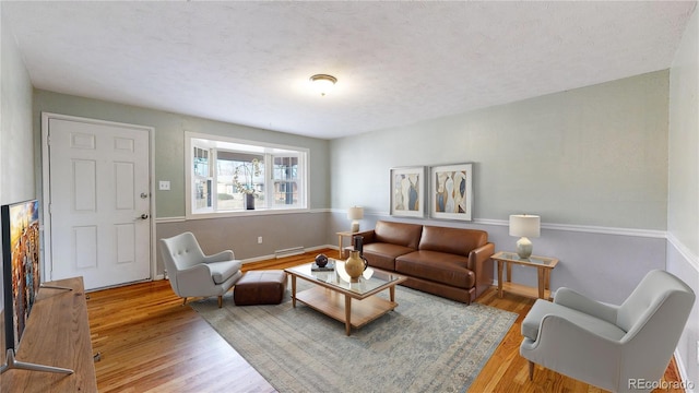 living room with hardwood / wood-style floors and a textured ceiling