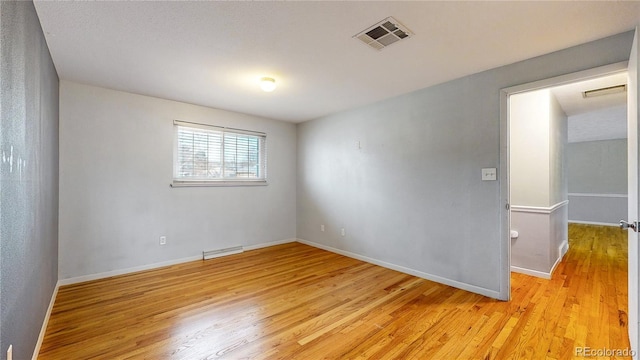 spare room with light hardwood / wood-style floors