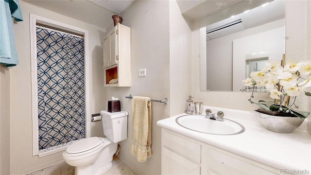 bathroom with a shower, vanity, toilet, and tile patterned flooring