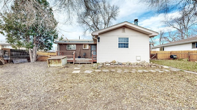 rear view of property with a wooden deck