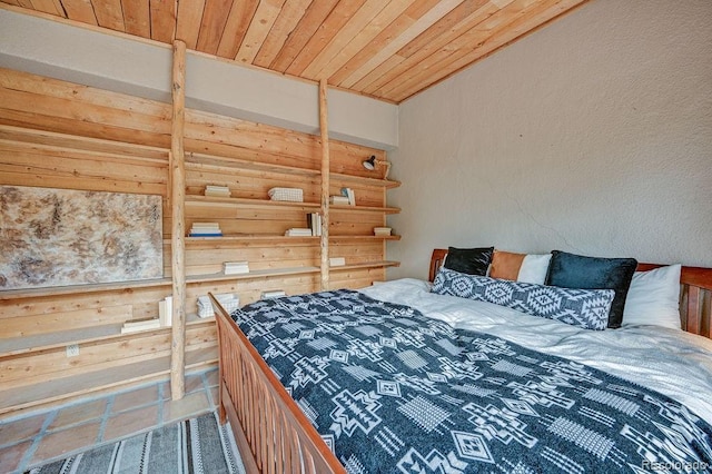 28700 County Road 304, Buena Vista, CO 81211 - tiled bedroom featuring wood ceiling and wooden walls
