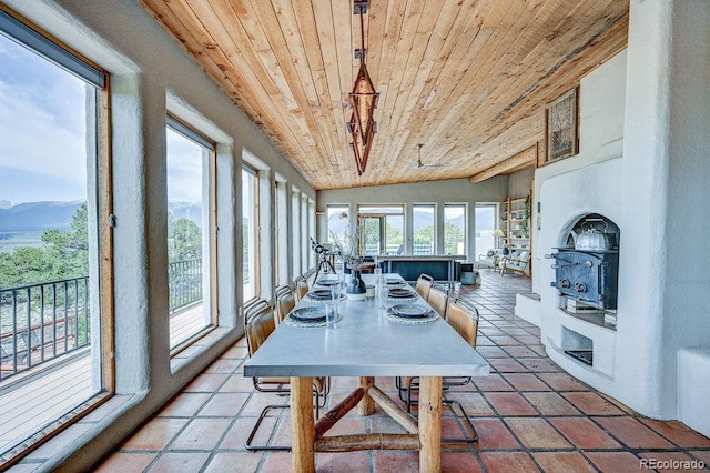 28700 County Road 304, Buena Vista, CO 81211 - sunroom with wooden ceiling, a mountain view, vaulted ceiling, and a wood stove