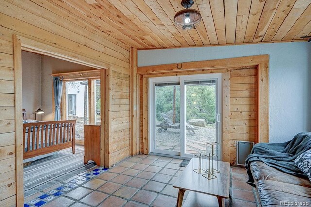 28700 County Road 304, Buena Vista, CO 81211 - entryway featuring wooden walls, wooden ceiling, vaulted ceiling, and light tile patterned floors
