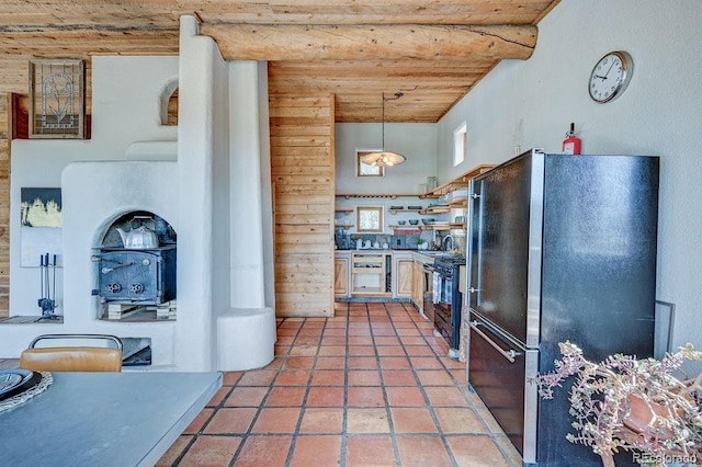 28700 County Road 304, Buena Vista, CO 81211 - kitchen with freestanding refrigerator, wood ceiling, open shelves, black stove, and hanging light fixtures