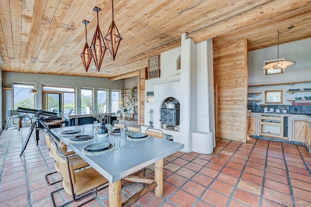28700 County Road 304, Buena Vista, CO 81211 - dining area featuring wooden ceiling, light tile patterned flooring, and a wood stove