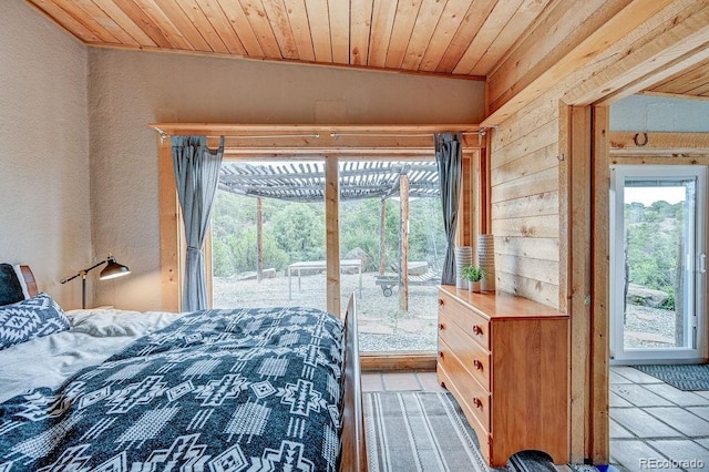 28700 County Road 304, Buena Vista, CO 81211 - bedroom featuring wooden ceiling, access to outside, a textured wall, light tile patterned flooring, and wood walls