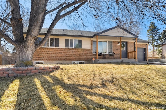 ranch-style house featuring a front lawn, brick siding, and an attached garage