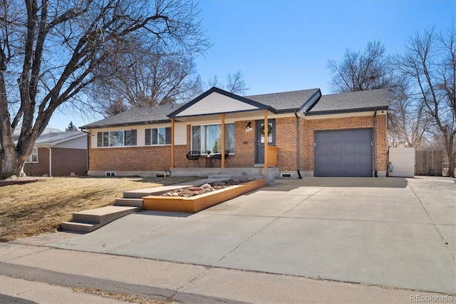 ranch-style house with a garage, fence, concrete driveway, and brick siding