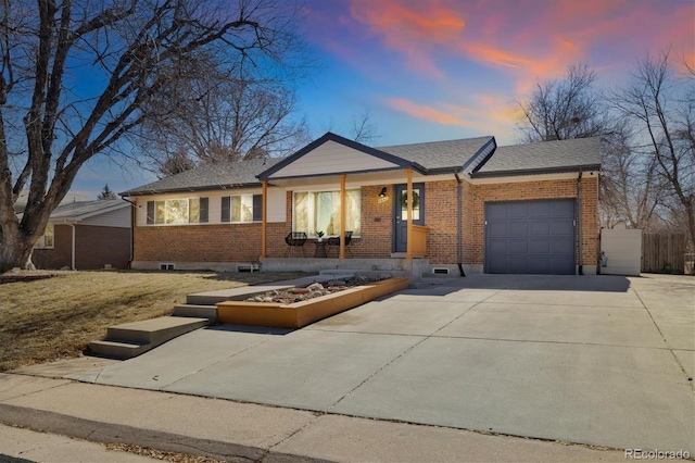 ranch-style house featuring driveway, roof with shingles, an attached garage, fence, and brick siding