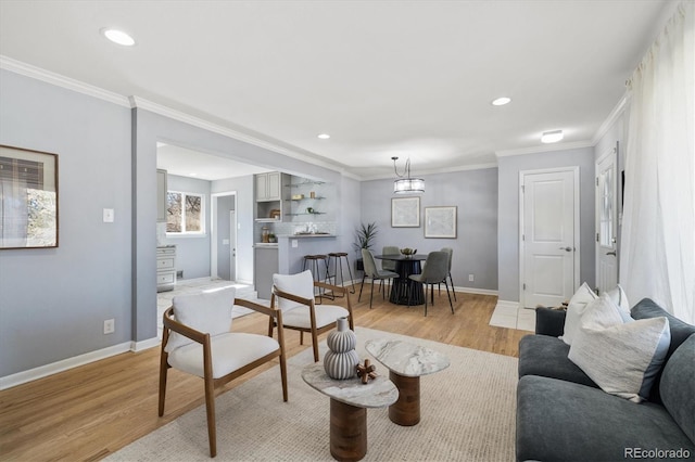 living area featuring ornamental molding, light wood finished floors, recessed lighting, and baseboards