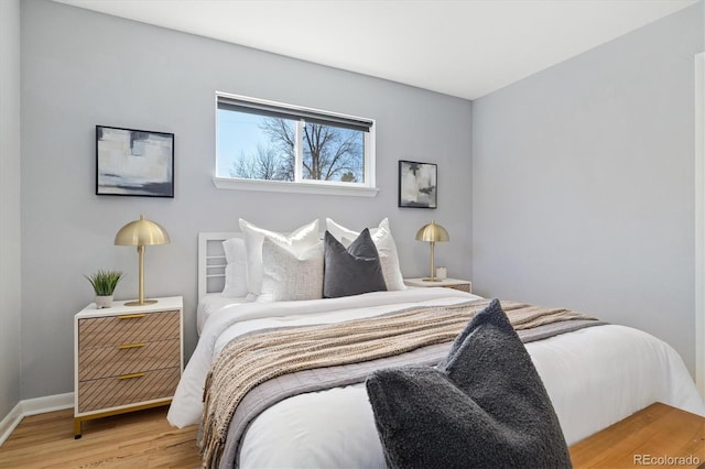 bedroom featuring baseboards and wood finished floors