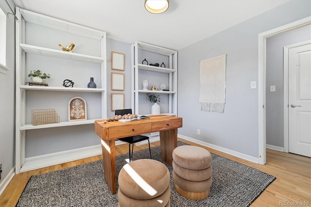 home office featuring light wood-type flooring and baseboards