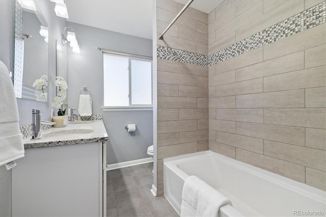 full bathroom with shower / bathtub combination, toilet, vanity, tile patterned flooring, and baseboards