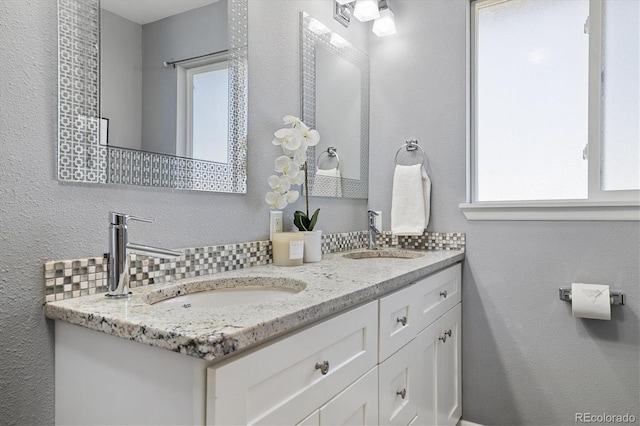 full bathroom featuring double vanity and a sink