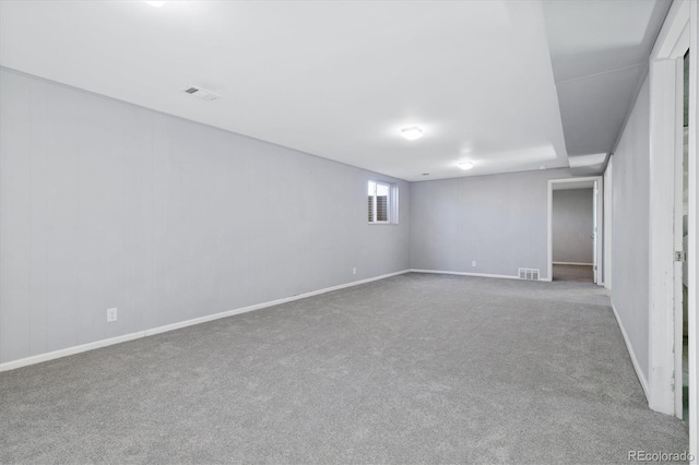 below grade area featuring carpet, visible vents, and baseboards