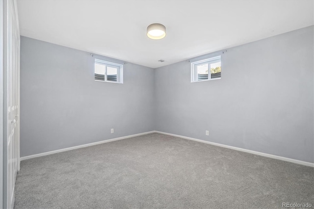 carpeted spare room with baseboards