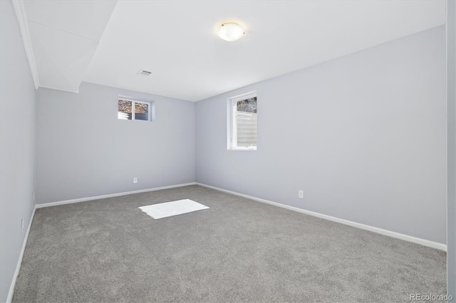 empty room featuring carpet flooring and baseboards