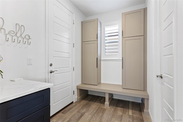 mudroom featuring light wood-style flooring and baseboards