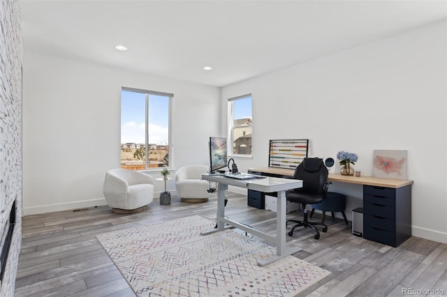 office featuring recessed lighting, wood finished floors, and baseboards