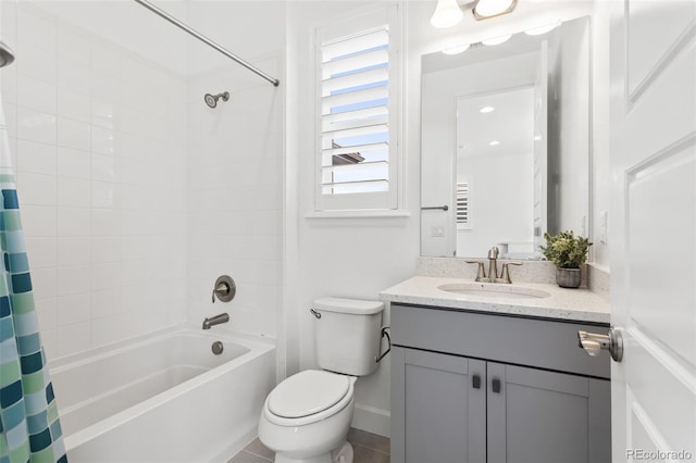 bathroom with toilet, baseboards, shower / bath combo with shower curtain, and vanity