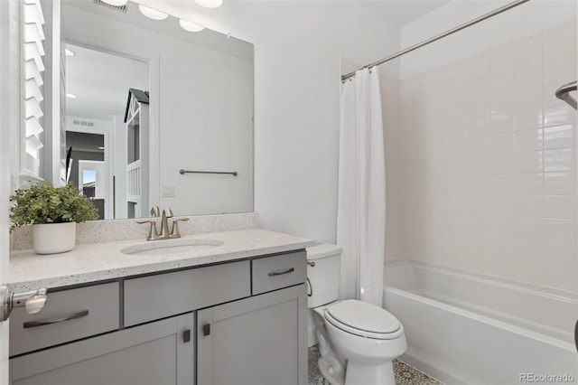 full bath with visible vents, shower / bath combo with shower curtain, vanity, and toilet