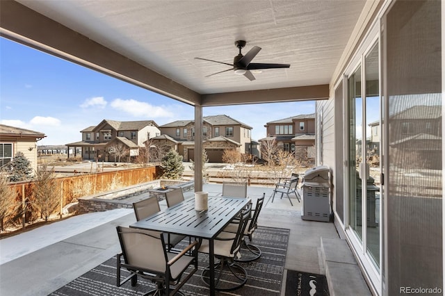 view of patio featuring an outdoor fire pit, outdoor dining area, area for grilling, a ceiling fan, and a residential view