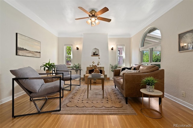 1434 Clermont St, Denver, CO 80220 - living area featuring plenty of natural light, wood finished floors, ceiling fan, and ornamental molding