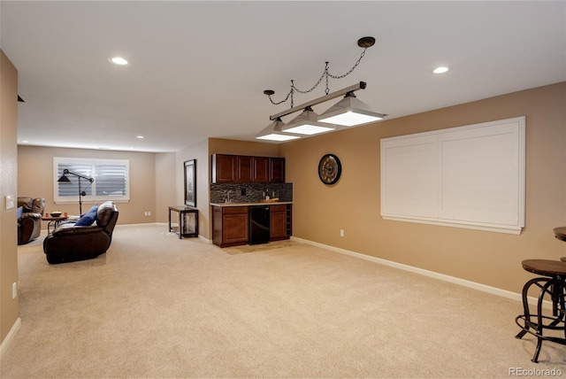 interior space featuring light carpet, recessed lighting, bar area, and baseboards