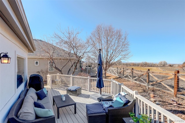 wooden deck with fence and outdoor lounge area