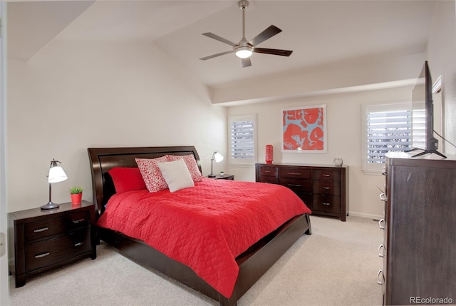 bedroom featuring light carpet, multiple windows, vaulted ceiling, and ceiling fan