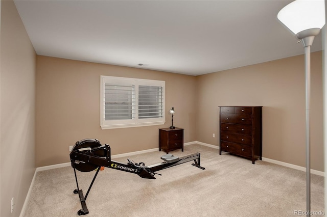 exercise area with carpet flooring, visible vents, and baseboards