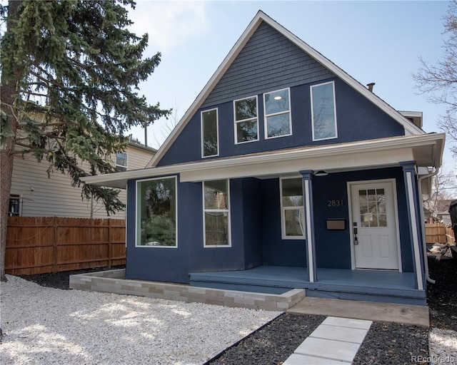 view of front of property featuring covered porch and fence