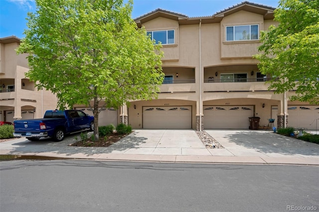 4323 Sammers Vw, Colorado Springs, CO 80917 - view of property featuring stucco siding, a garage, driveway, and a tiled roof