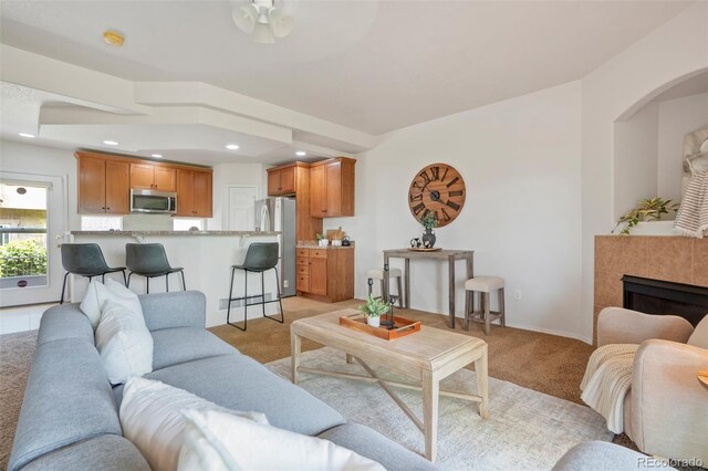 4323 Sammers Vw, Colorado Springs, CO 80917 - living room featuring light colored carpet, a ceiling fan, recessed lighting, and a tile fireplace