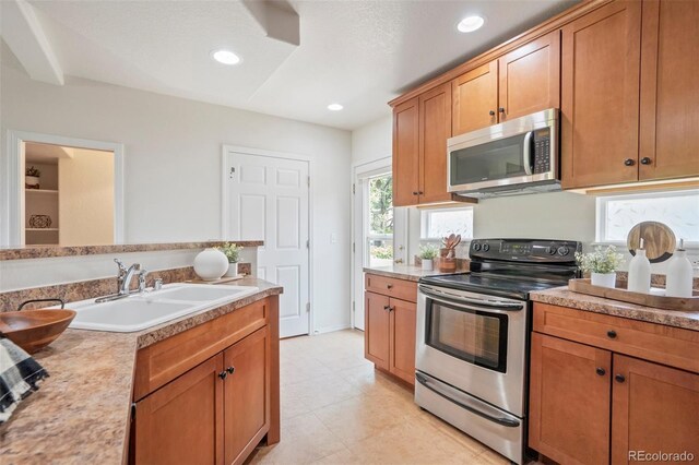 4323 Sammers Vw, Colorado Springs, CO 80917 - kitchen featuring appliances with stainless steel finishes, a sink, light countertops, brown cabinets, and recessed lighting