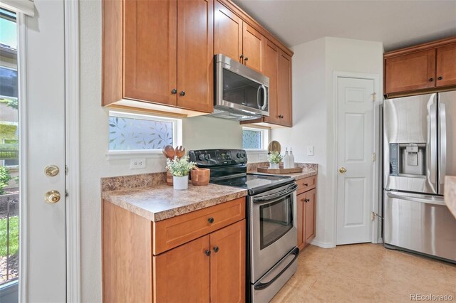4323 Sammers Vw, Colorado Springs, CO 80917 - kitchen with appliances with stainless steel finishes, light countertops, and brown cabinetry